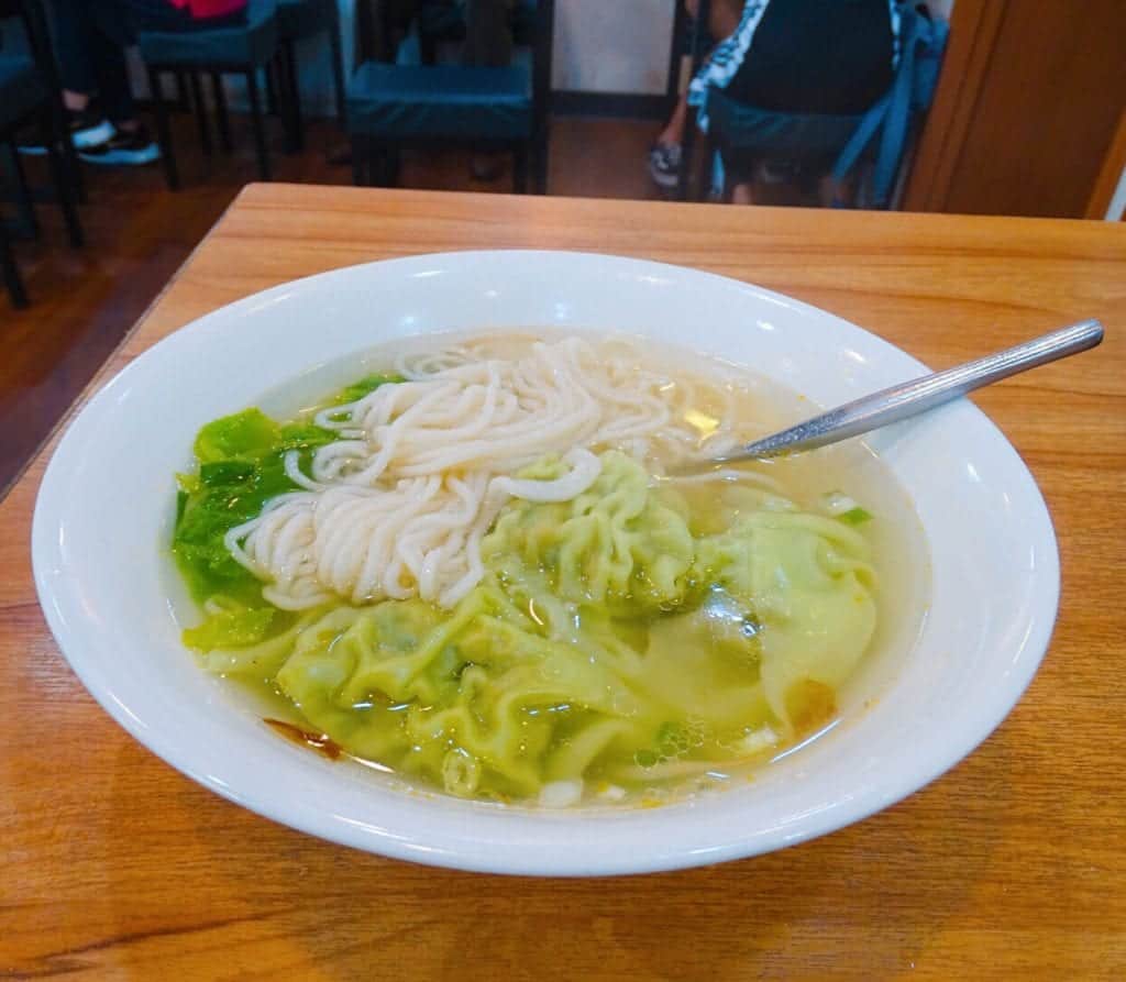 Bowl of dumplings in a noodle soup