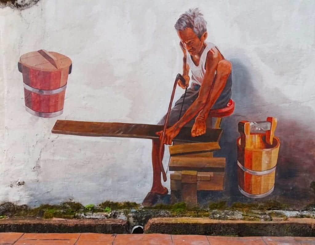 Man at work street art Melaka 