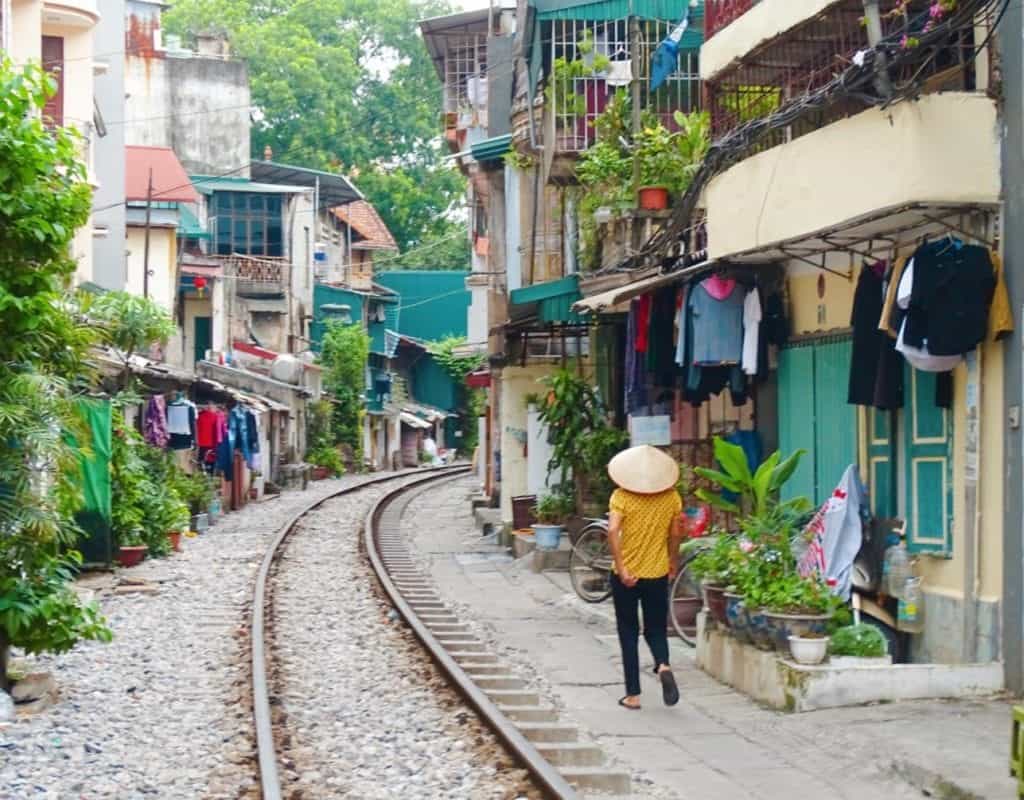 Local women walking down Train Street Hanoi