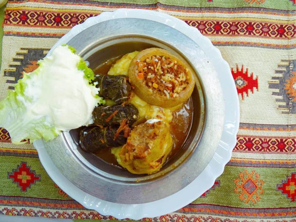 Plate of rice, dolma, lettuce and sour cream at a Mostar restaurant