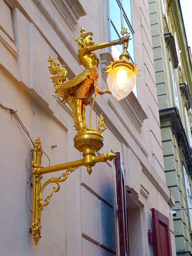 Gold statue holding street light 3 days in Vienna