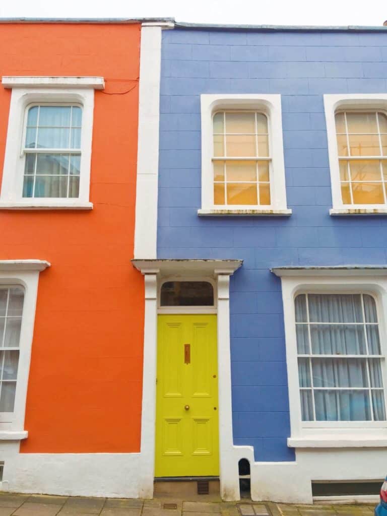 Yellow doorway between purple and orange houses in Bristol