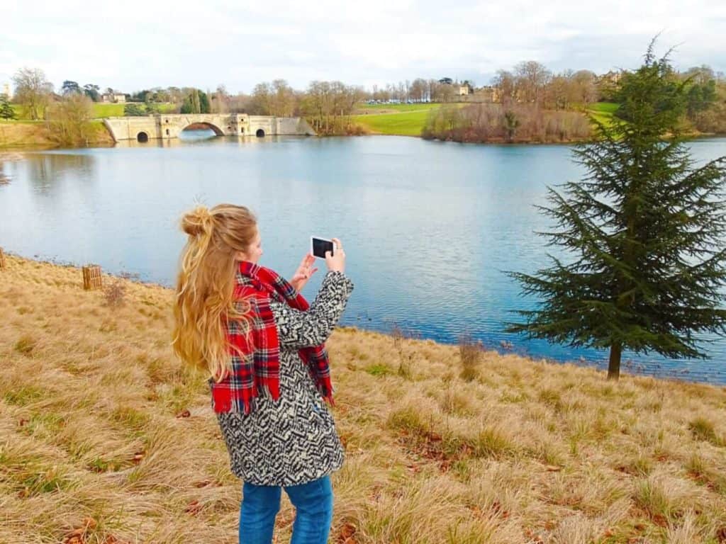 Girl taking photo of Blenheim Palace bridge