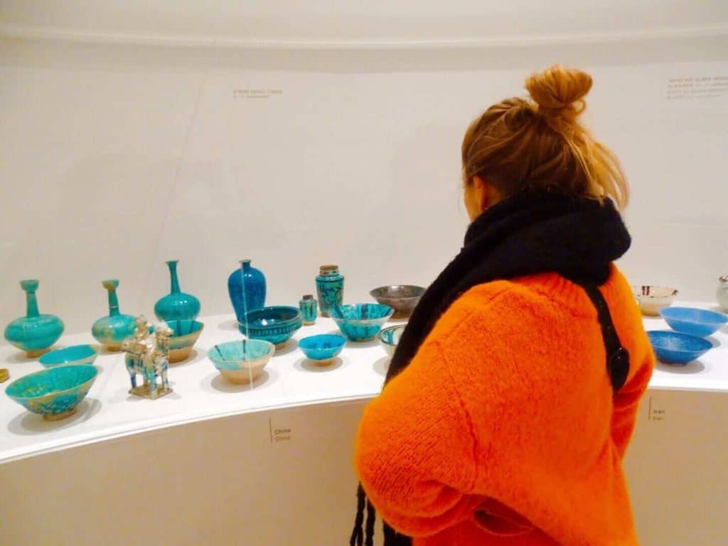 Girl looking at pottery in Hamburg museum