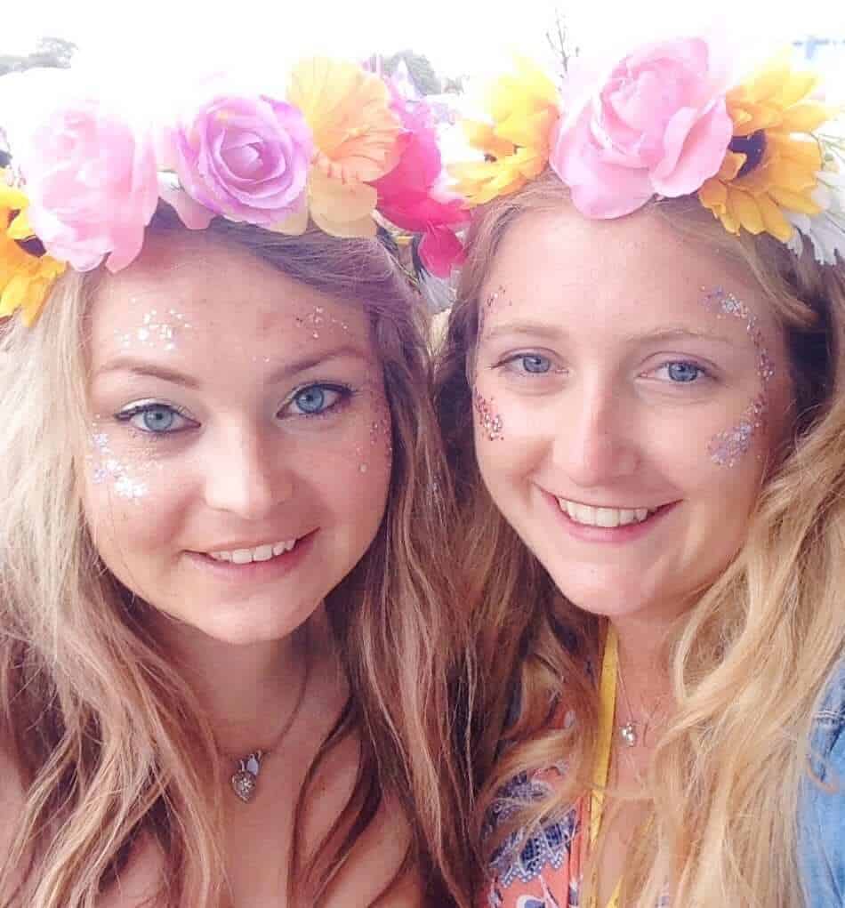 Girls wearing flower garland headbands Glastonbury 