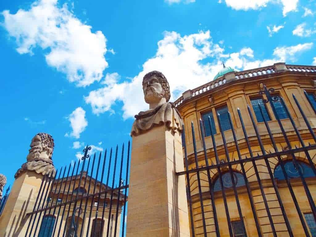 Stone heads outside Sheldonian Theatre Oxford