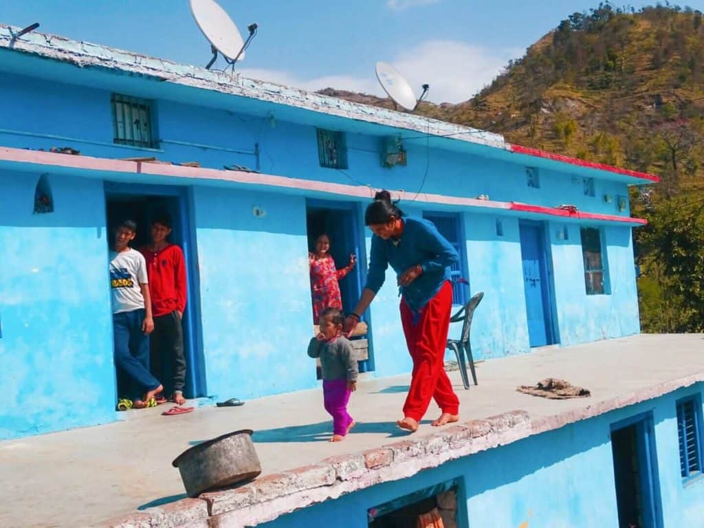 Family in blue house Rishikesh India 