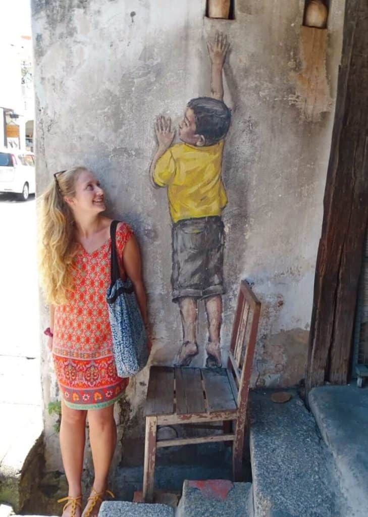 Child reaching up mural