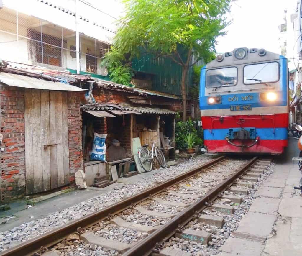 Train coming through street Hanoi 