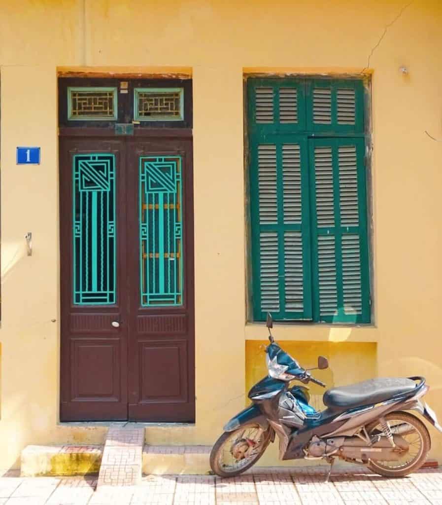 Scooter against yellow wall Truc Bach Hanoi