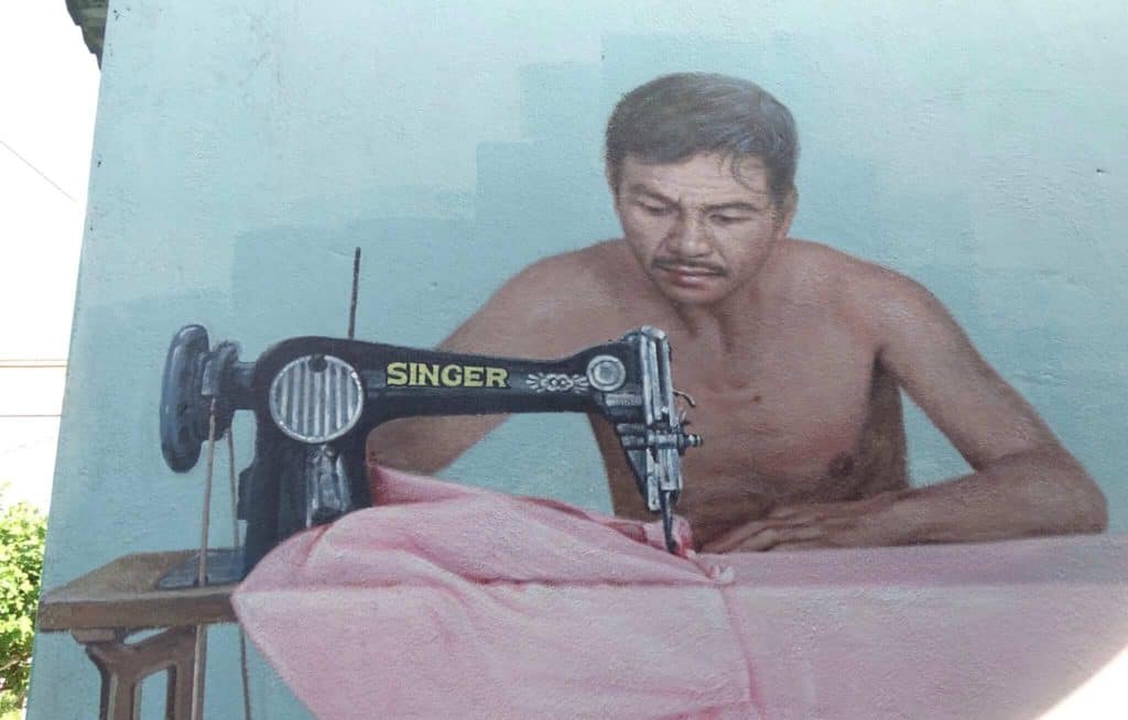 Man sewing street art 