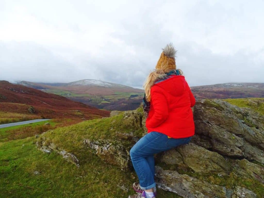Girl in red coat looking over Old Coniston hike