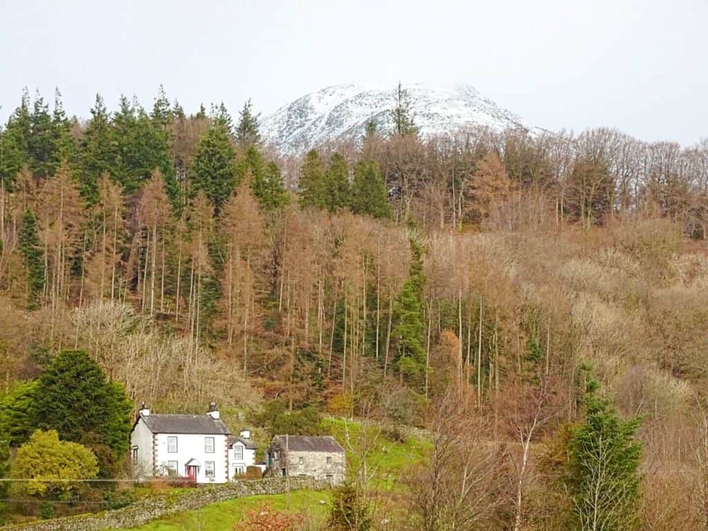 White cottage with mountain backdrop Lake District