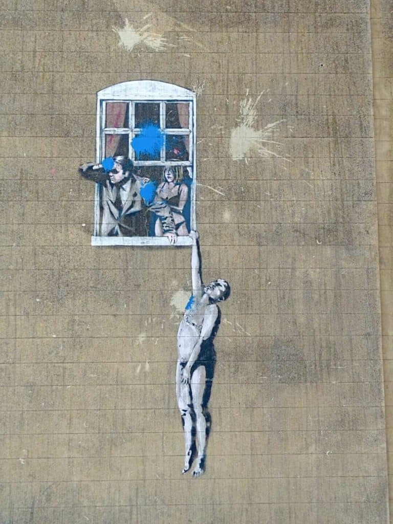 hanging man street art Banksy