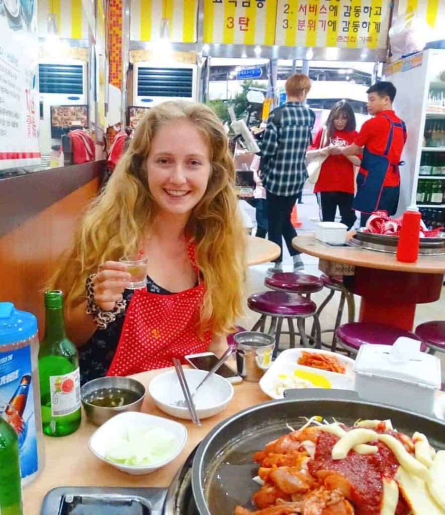 A dak galbi and soju meal in a busy restaurant