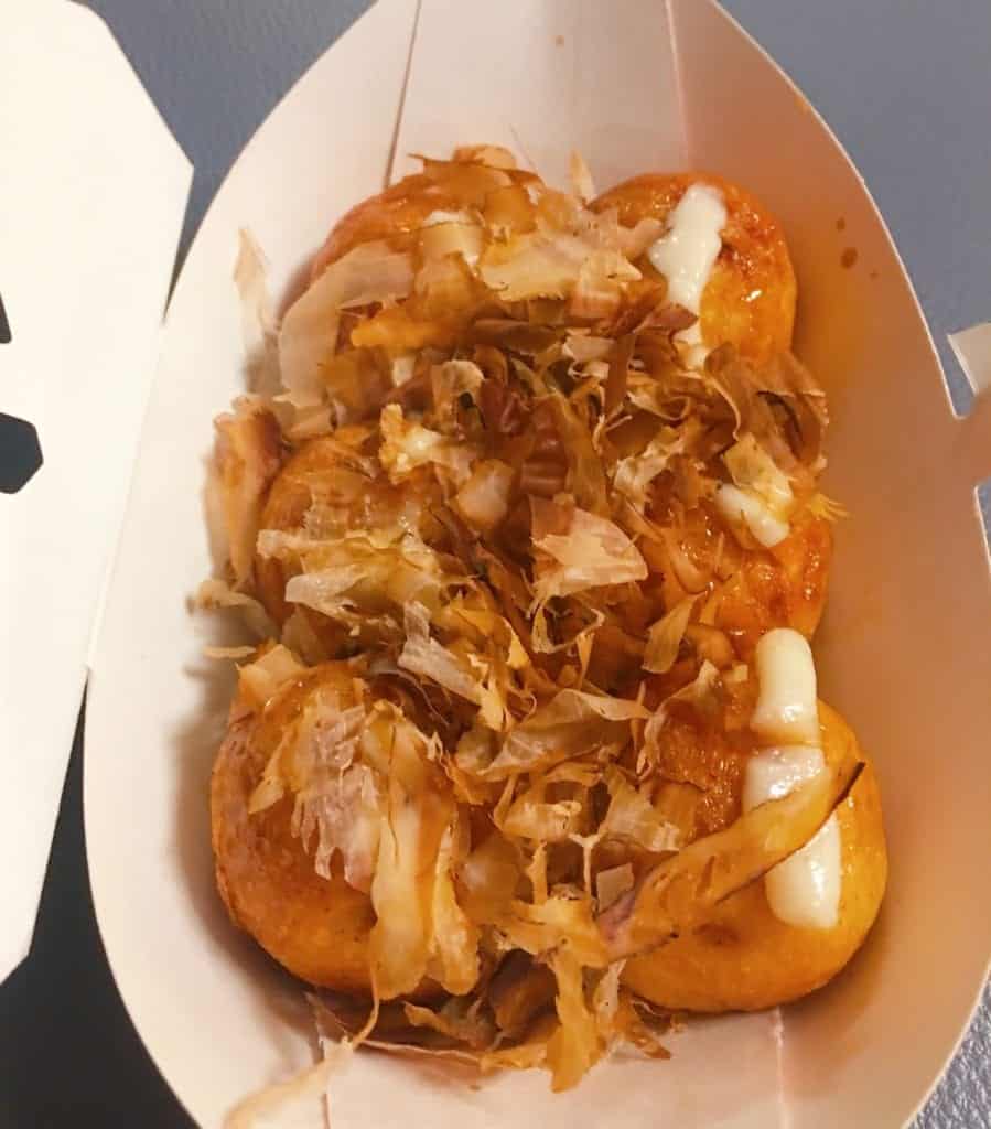 Box of six takoyaki dumplings topped with mayo and seaweed flakes