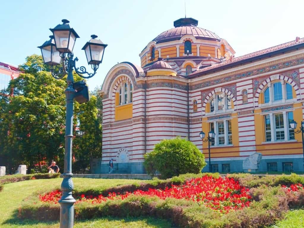 Ornate lamp post beside yellow and red Central Mineral Baths Sofia 